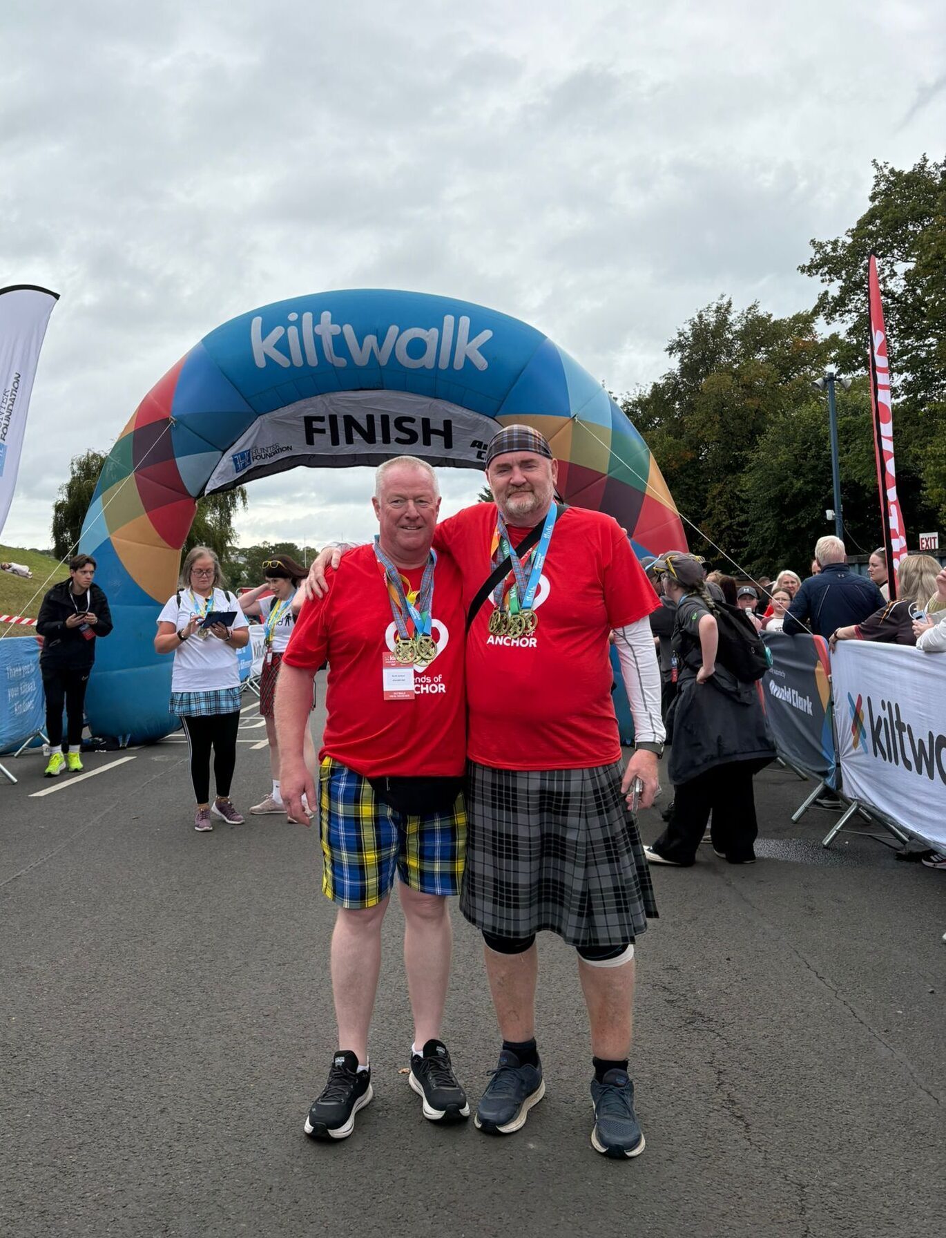 Scott and Mark at the final finish line with all medals